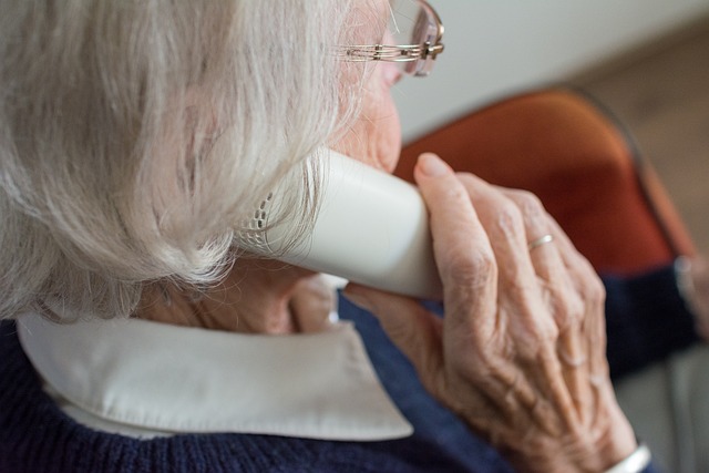 Female senior citizen talking on a phone.